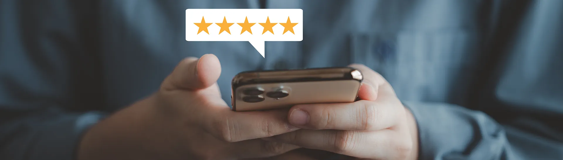 A person looking down a their phone providing a star rating about a site.