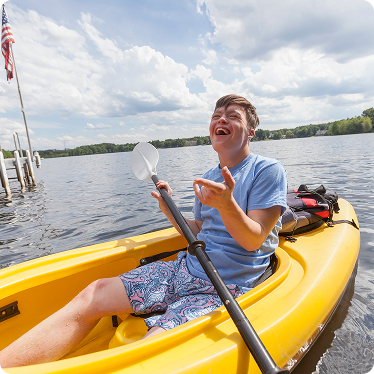 Young boy kayaking in yellow kayak
