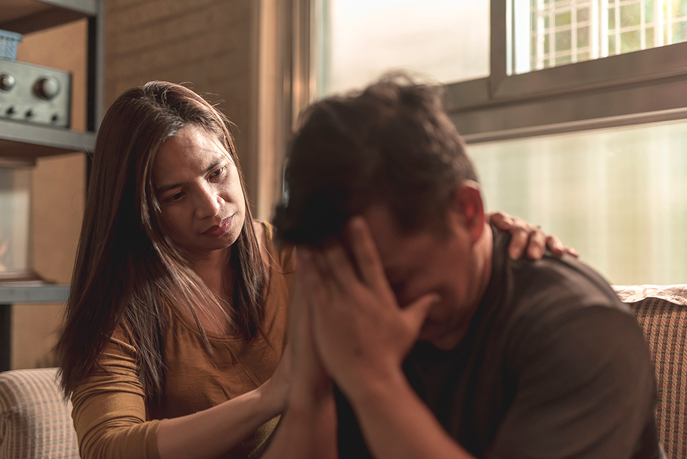 A therapist consoling a patient with mental health issues.