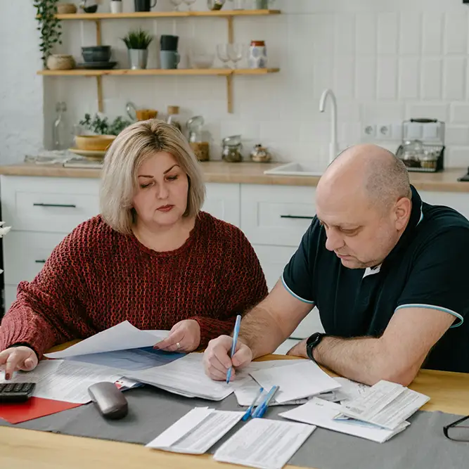 A husband and wife going reviewing healthcare documents.