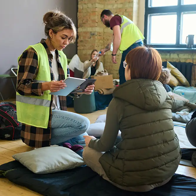Workers help people who are in need at a shelter.